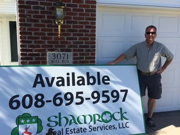 Jeff Daugherty with Shamrock Real Estate Services signage